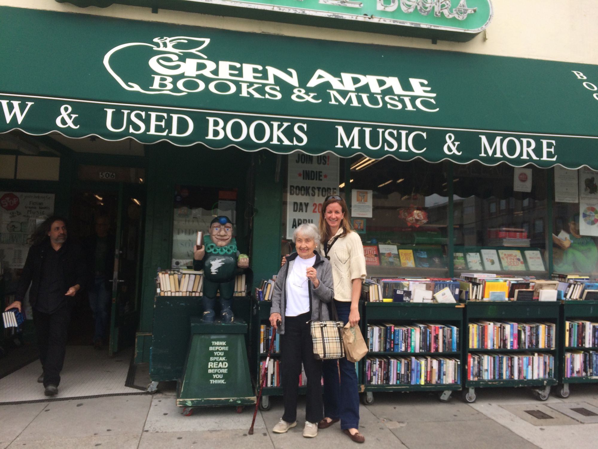 Two people in front of bookstore.