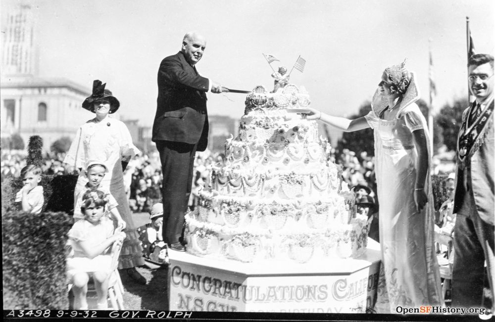 Man cutting large cake. 