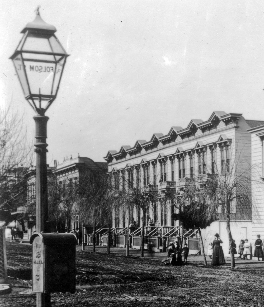 Lamp post, mailbox, street, and houses.