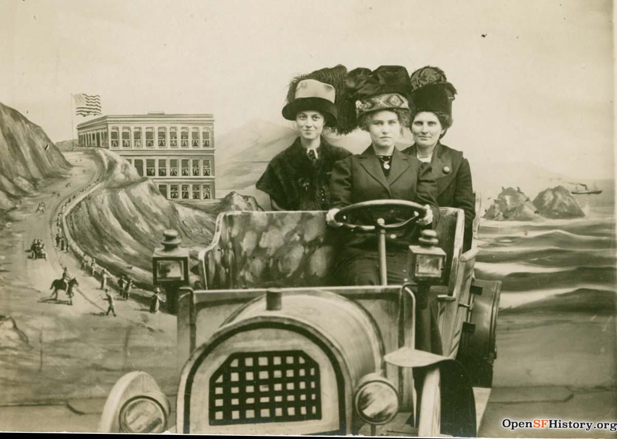 3 be-hatted women in a souvenir photo